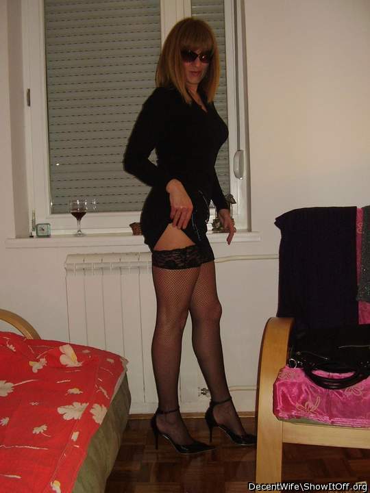 What a sexy lady.  Beautiful legs and tits in that dress.   